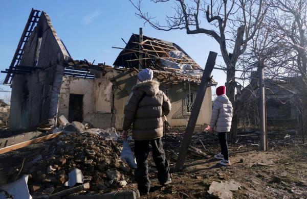 People inspecting the damage to buildings after the overnight attack.