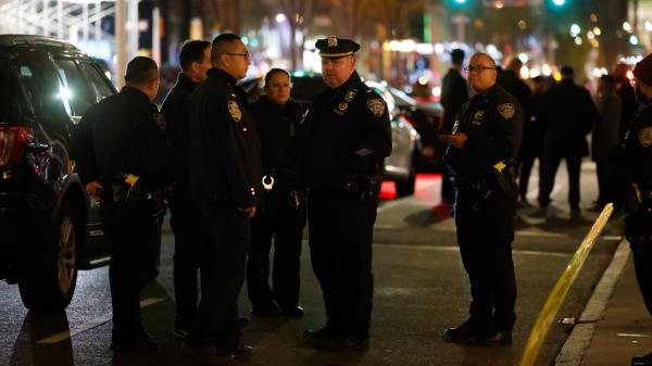 Police officers gather on a street in Manhattan wher<em></em>e the 18-year-old was fatally stabbed Friday night.