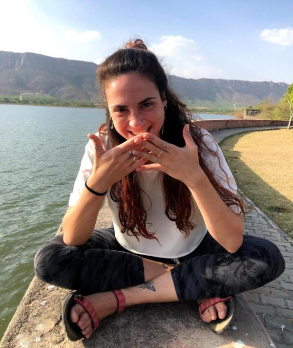 Inbar Haiman smiles while sitting near a lake