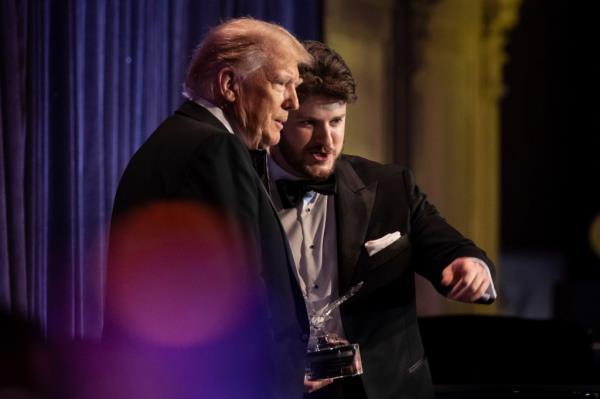 Former President Do<em></em>nald Trump and Gavin Wax, president of the New York Young Republican Club, stand on stage during the club's annual gala at Cipriani Wall Street, Saturday, Dec. 9, 2023. (AP Photo/Yuki Iwamura)