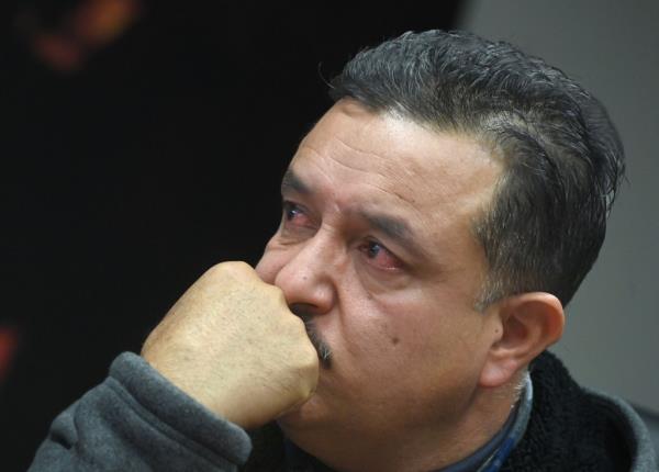 Slain officer's dad crying.