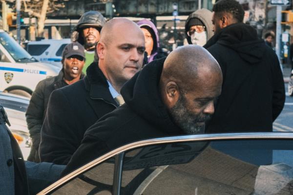 Danny Daniel is walked from the 81st precinct to a NYPD vehicle en route to Brooklyn Criminal Court. 