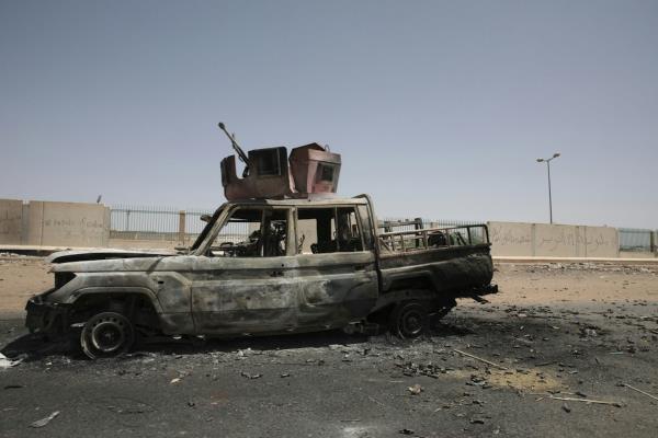 Burned-out truck on the road.